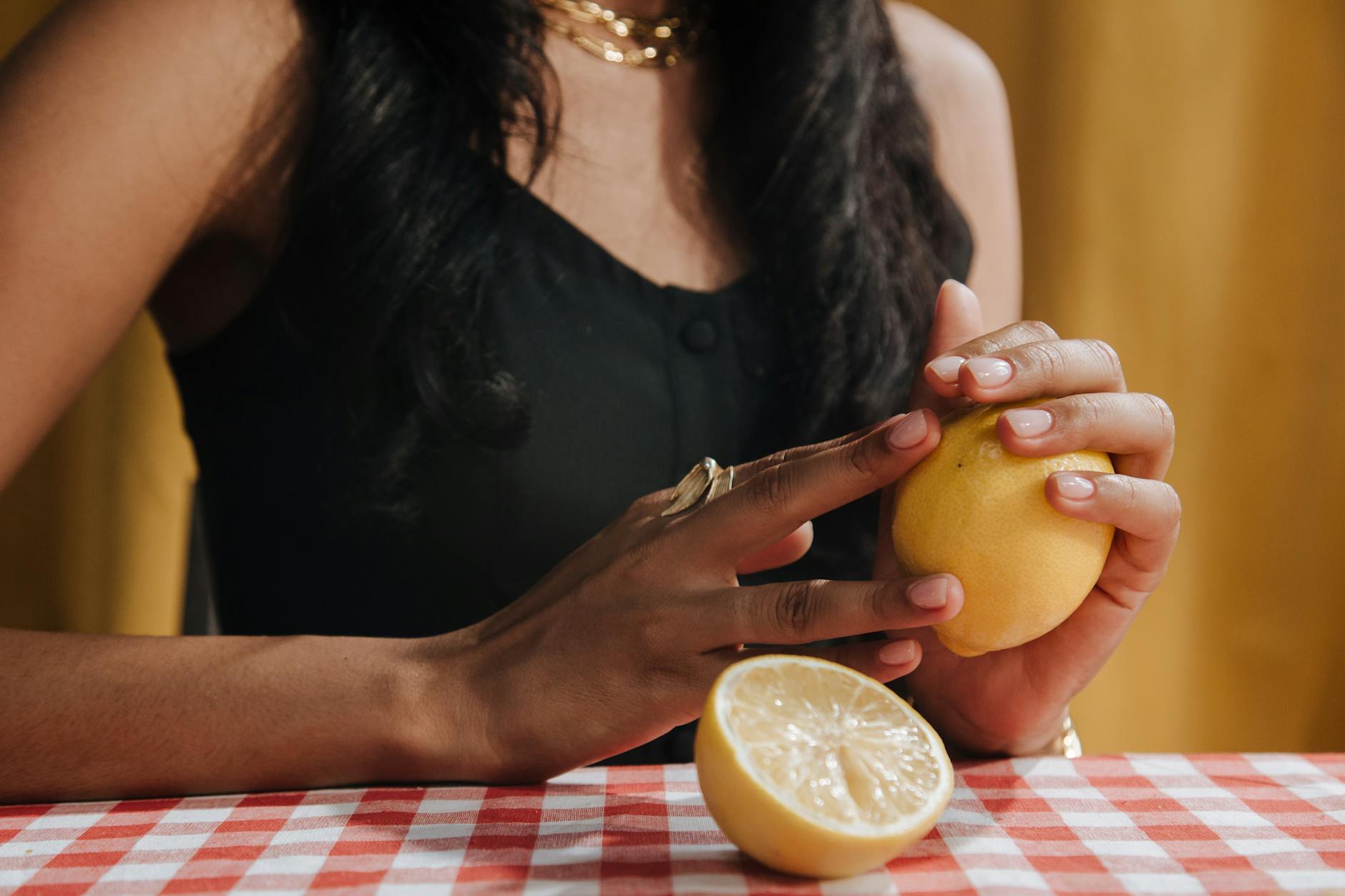 A hand holding a vibrator against a purple backdrop, demonstrating modern sensuality and sexual wellness
