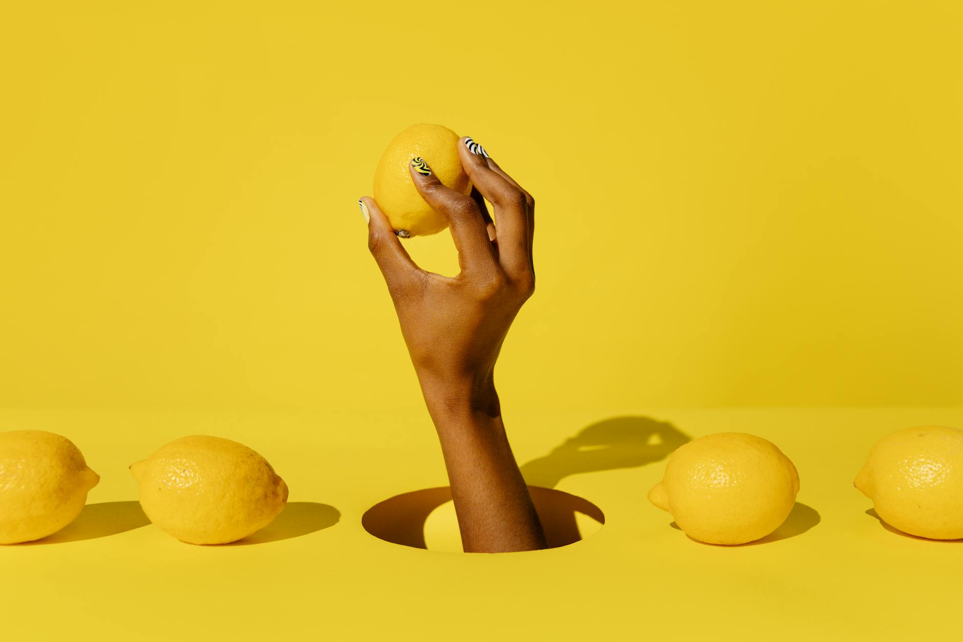 Bright yellow lemons arranged on a pastel green background, symbolizing the fun, approachable design of lemon clitoral vibrators