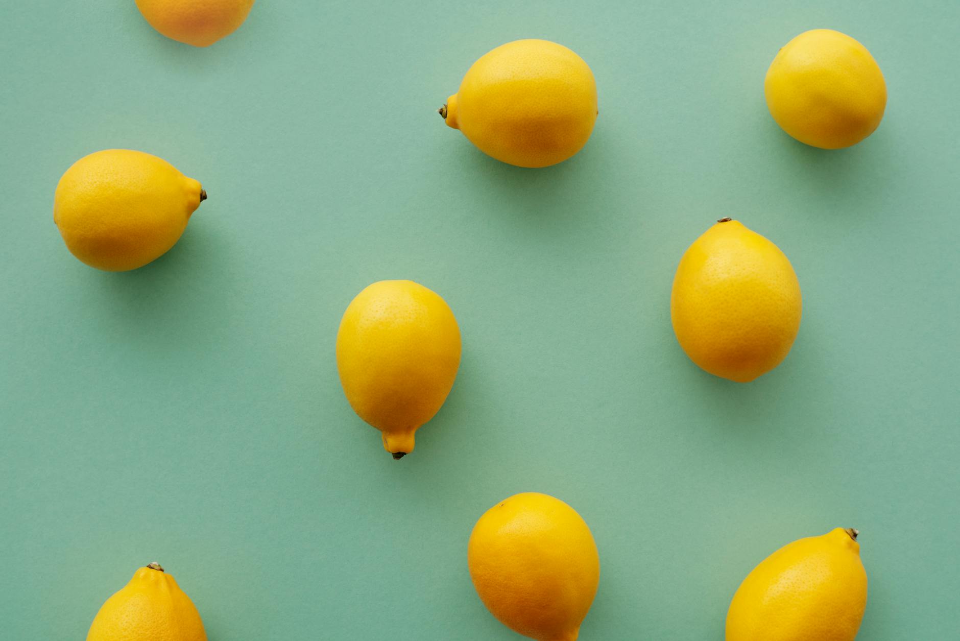 Bright yellow lemons arranged on a pastel background symbolizing fresh intimacy